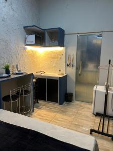 a kitchen with blue cabinets and a counter top at Pousada É de casa unidade 02 apto 01 in Juazeiro do Norte