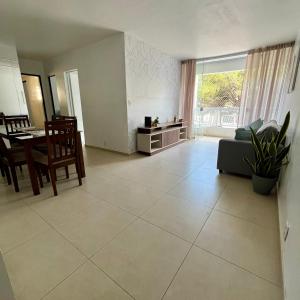 a living room with a table and a couch at Cantinho 108 in São Luís