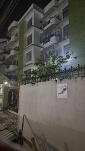 a building with a sign on the side of a wall at Mayabini Homestay 3BHK in Guwahati