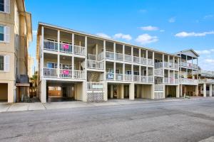 an apartment building with balconies and a street at Tybee Turtle in Tybee Island