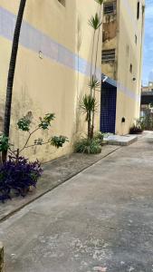 a building with a palm tree next to a street at Cantinho 108 in São Luís