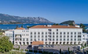 a large white building with a view of the water at Crowne Plaza Budva by IHG in Budva