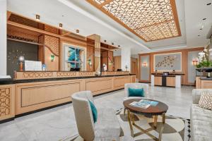 a salon with a waiting room with a table and chairs at Crowne Plaza Budva by IHG in Budva