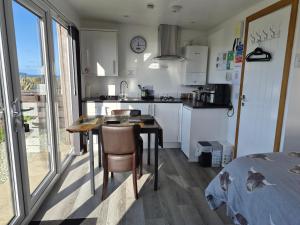 a kitchen with a table and chairs in a room at Lampay Chalets in Dunvegan +55 photos