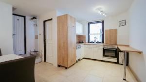 a large kitchen with white cabinets and a window at MareVita in Tribunj
