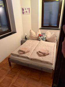 a bed in a room with two pillows on it at MareVita in Tribunj