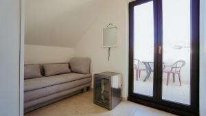 a living room with a couch and a tv at MareVita in Tribunj
