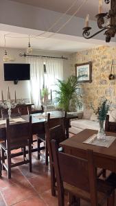 a dining room with wooden tables and chairs at Eco de las Cuevas in Santillana del Mar