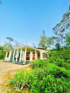 a small house in the middle of a field at Yemi Bungalow Ella in Ella