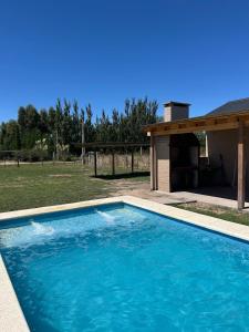 a large blue swimming pool in front of a building at Quintasdeconde in San Miguel del Monte