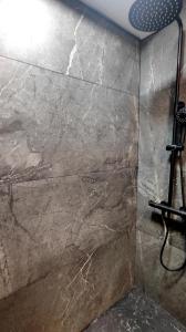 a stone wall in a bathroom with a shower at La Terraza de La Línea in La Línea de la Concepción +30 photos