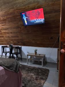 a living room with a tv hanging on the wall at Elshadaychale in Ibiúna