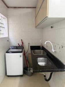 a kitchen with a sink and a small refrigerator at Apartamento de Denise in Aracaju +23 photos