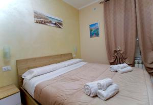 a bedroom with a bed with towels on it at Raggio di Sole Suite in Valmontone