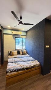 a bed in a room with a ceiling fan at 7 Star Hotel in Surat