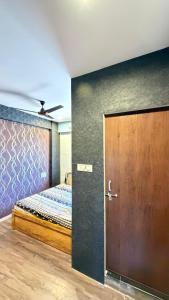 a bedroom with a door leading to a bed at 7 Star Hotel in Surat