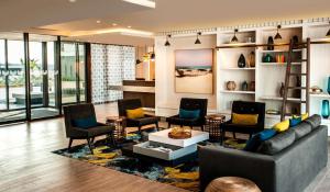 a living room with a couch and chairs and a table at StayEasy Maputo in Maputo