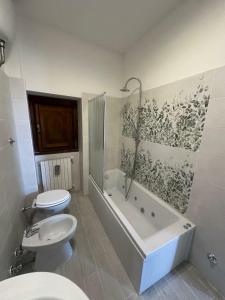 a bathroom with a toilet and a tub and a sink at Sospesi nel borgo in Vitorchiano +78 photos