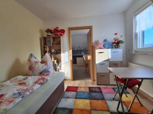a bedroom with a bed and a table and a desk at Ferienwohnung Spatzennest in Lauter