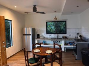a kitchen with a table and a kitchen with a refrigerator at Villa Nomad in Naranjito