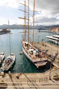 two boats are docked at a dock in the water at Perla Marina - HelloElba in Portoferraio