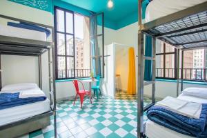 a room with two bunk beds and a table at Ostello Bello Napoli in Naples