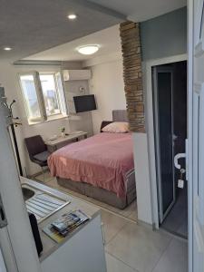 a bedroom with a bed and a table with a table at Stone Guest House in Split