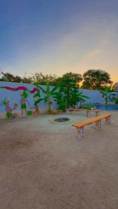 a wall with a bench in a park with a mural at Las siete lunas in Ucú +3 photos