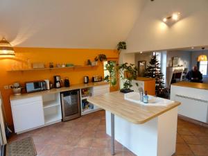 a kitchen with white cabinets and a counter top at Moulin XVe siècle - Gîte privatif 8 pers - Rivière - Châteaux de la Loire in Vineuil +24 photos