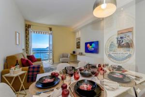 a living room with a table with food on it at Desenzanoloft Garda Golden Sunrise official partner Homes and Villas By Marriott Bonvoy in Desenzano del Garda