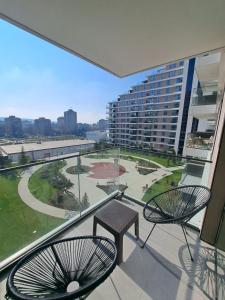 a balcony with two chairs and a view of a park at Tea Planet 2 in Niš