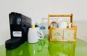 a table topped with a coffee maker and a microwave at Kundera Hotel Boutique in Colima +17 photos