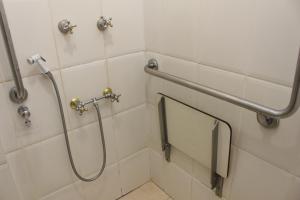 a shower stall in a bathroom with a shower curtain at Actuall Convention Hotel in Contagem +11 photos