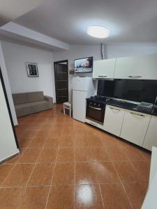 a living room with a kitchen and a couch at Apartment 3 by Villa Ceni in Elbasan