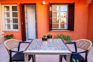 a table and chairs sitting on a patio at Alegria Pension in Chania
