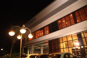 a building with cars parked in front of it at night at Actuall Convention Hotel in Contagem