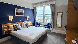 a hotel room with a large bed and a window at Manor Hotel in Exmouth +75 photos