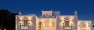 a white building is lit up at night at Galation in Mikonos