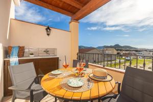 a table and chairs on a balcony with a view at Agorà Apartments in Villasimius
