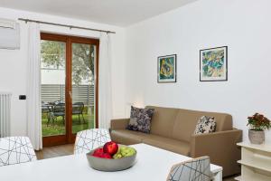 a living room with a couch and a bowl of fruit on a table at Casa Carla in Nago-Torbole +64 photos