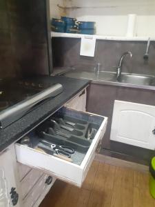 a kitchen with a drawer full of utensils at Refúgio da Estrela Covilhã in Covilhã