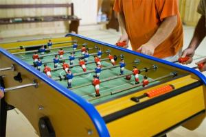 a group of people standing next to a pool table at Gîte Le Charme in Aspach-le-Bas