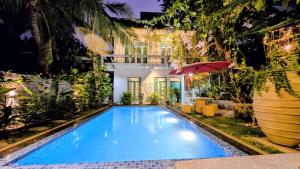 a swimming pool in front of a house at Soul Villas in Tangalle