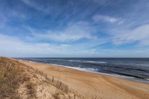 a sandy beach with the ocean in the background at 4209 - Moby Duck in Duck