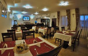 a restaurant with tables and chairs and a dining room at Hotel Joseph 1699 in Třebíč