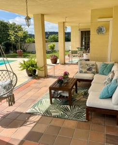 a patio with couches and a table on a patio at Mar De Frisia in O Pino 