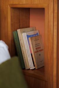 three books are sitting on a book shelf at Babel Lille Centre in Lille