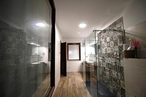 a bathroom with two sinks and a glass shower at Casale Sienti'n Può in Norcia +18 photos