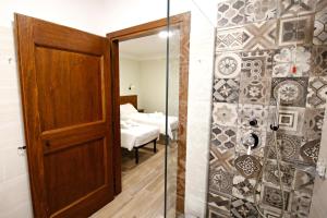 a bathroom with a shower and a glass door at Casale Sienti'n Può in Norcia