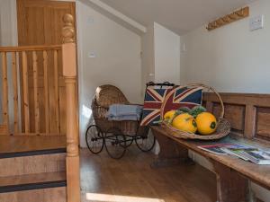 a hallway with a basket of fruit on a table at Freshwater Barn in Benenden +11 photos